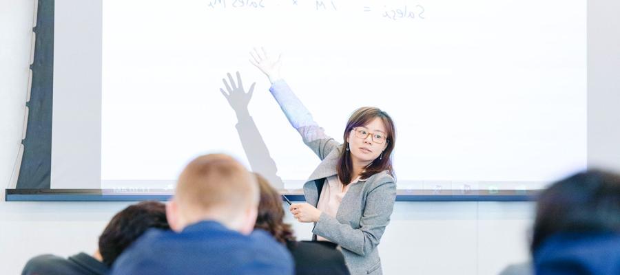 Female facutly member in front of a class of undergraduate students